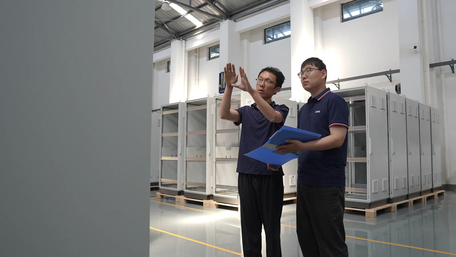 Engineers reviewing cabinet assembly quality against drawings